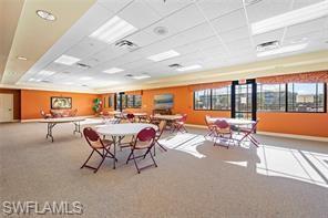 8570 Kingbird Loop, Unit 547 Estero, FL 33967 - Photo 49 of 50 a living room with furniture a fireplace and a large window