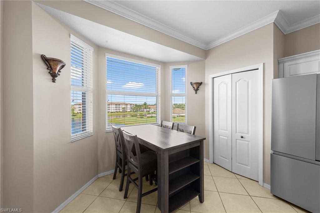8570 Kingbird Loop, Unit 547 Estero, FL 33967 - Photo 8 of 50 a kitchen with stainless steel appliances granite countertop a refrigerator and a sink