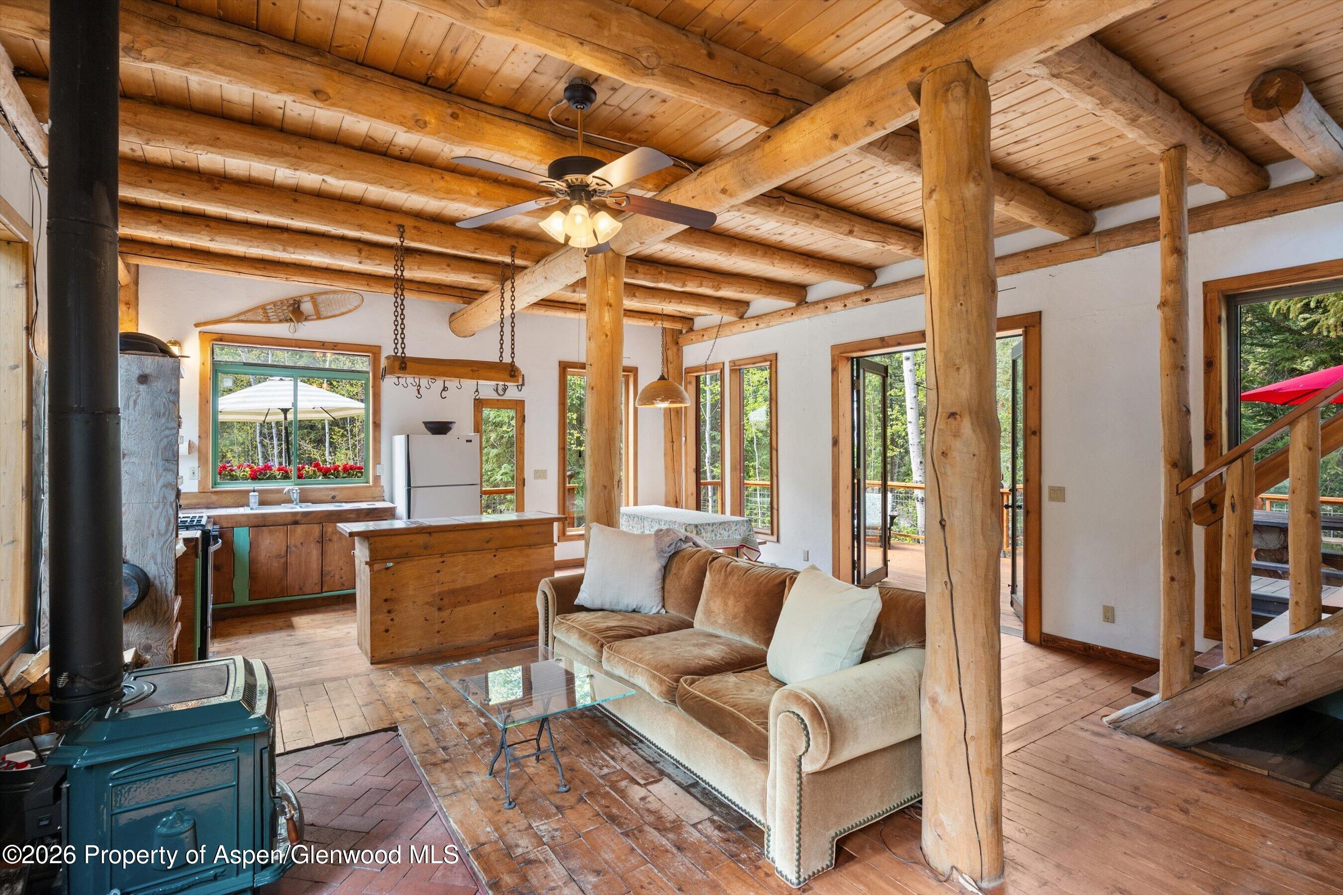 26608 Frying Pan Road Meredith, CO 81642 - Photo 16 of 49 a living room with furniture a flat screen tv and a table