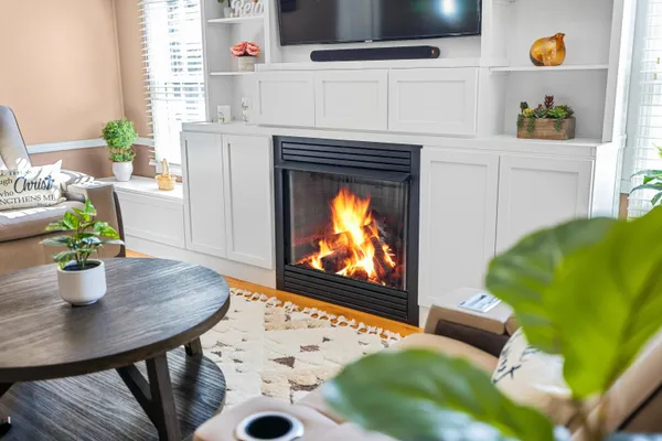 a living room with furniture and a fireplace