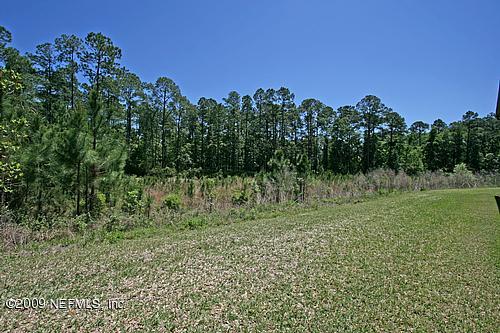 9745 Touchton Road, Unit 927 Jacksonville, FL 32246 - Photo 12 of 22 a view of a green field with lots of bushes