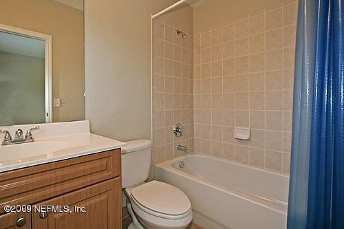 9745 Touchton Road, Unit 927 Jacksonville, FL 32246 - Photo 8 of 22 a bathroom with a granite countertop toilet a sink and bathtub