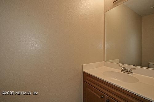 9745 Touchton Road, Unit 927 Jacksonville, FL 32246 - Photo 9 of 22 a bathroom with a sink and a mirror