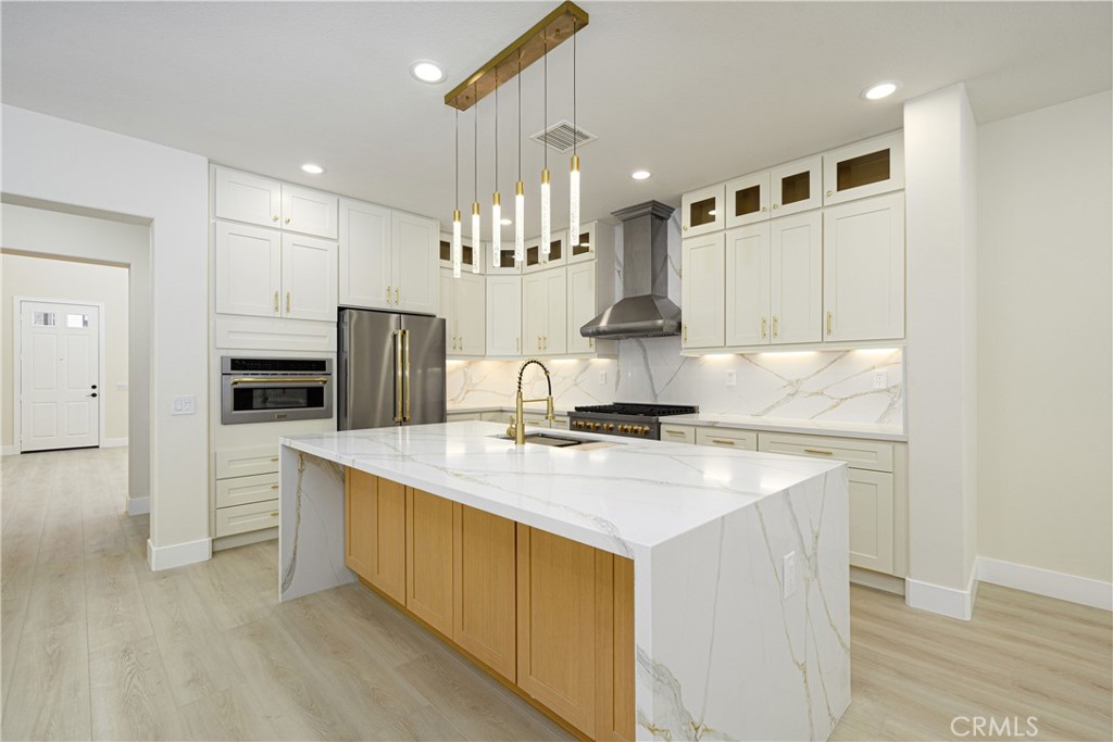 15 Plum Street Ladera Ranch, CA 92694 - Photo 22 of 113 a kitchen with kitchen island a sink stainless steel appliances and cabinets