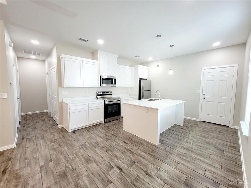 815 East Starr Road, Unit C Mercedes, TX 78570 - Photo 4 of 12 a view of kitchen with wooden floor