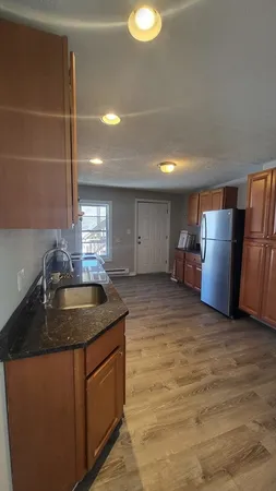 a kitchen with refrigerator and window