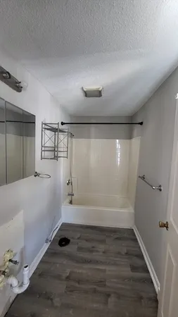a bathroom with a bathtub and a shower