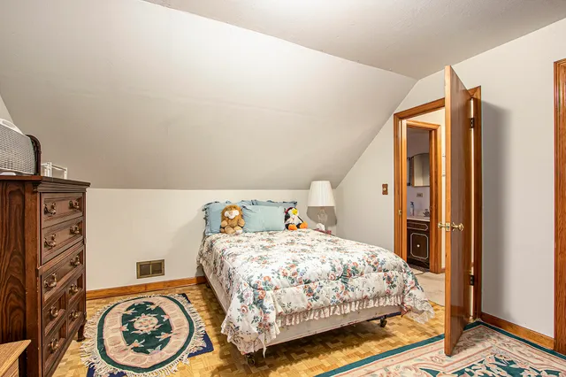 a bedroom with a bed and a tv on the dresser