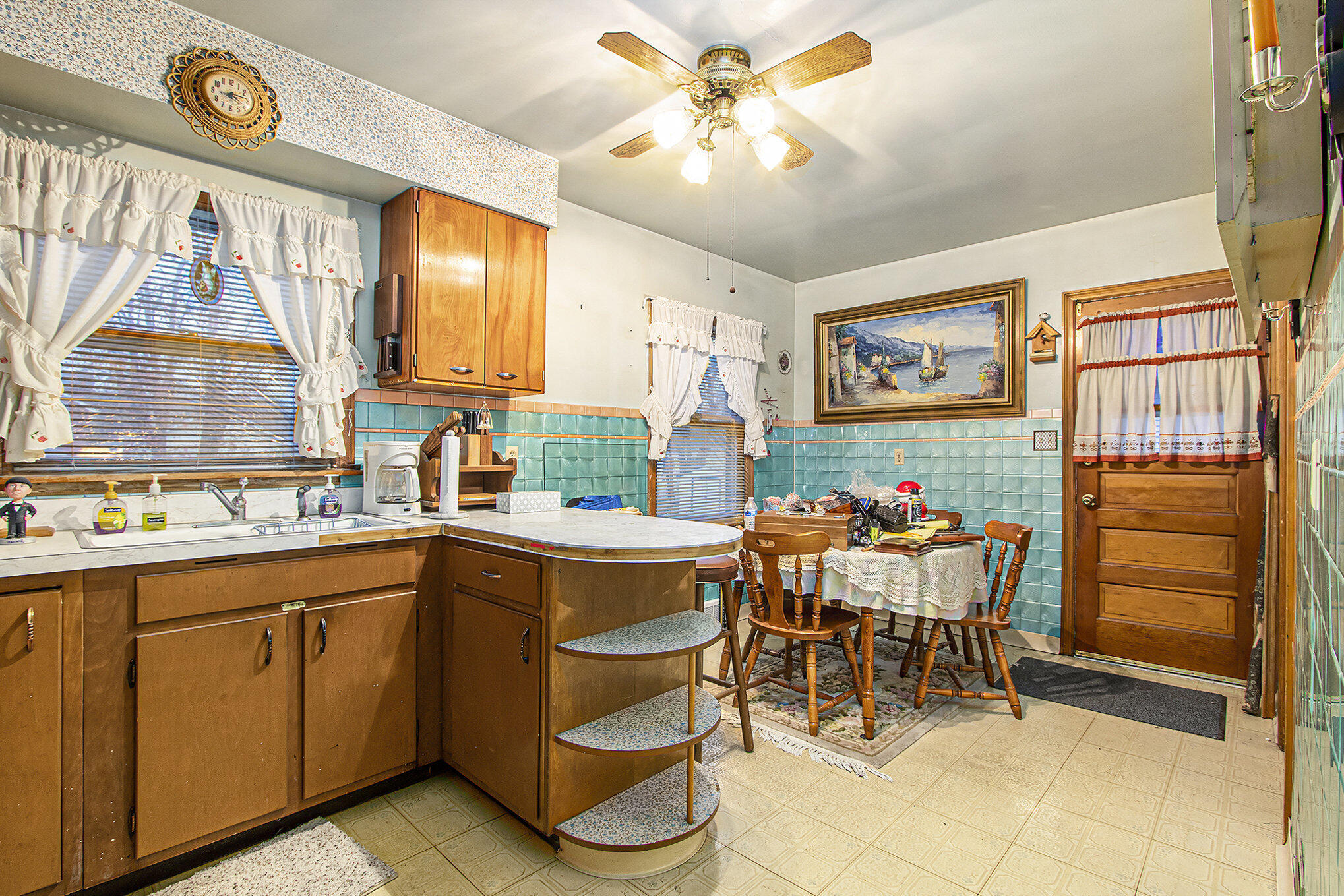 1027 Spruce Street Hammond, IN 46324 - Photo 5 of 17 a kitchen with a cabinets and chairs