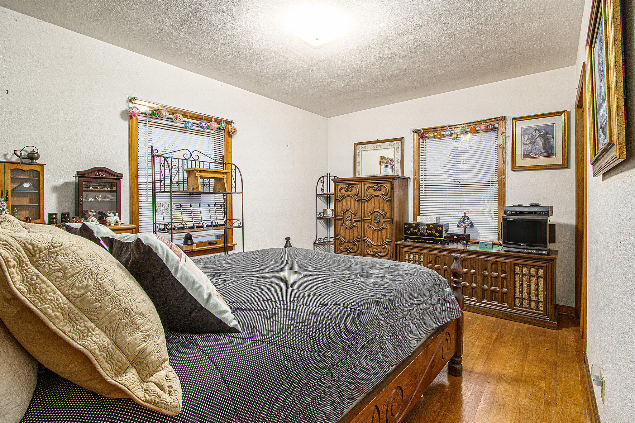 1027 Spruce Street Hammond, IN 46324 - Photo 8 of 17 a bedroom with a bed and a dresser