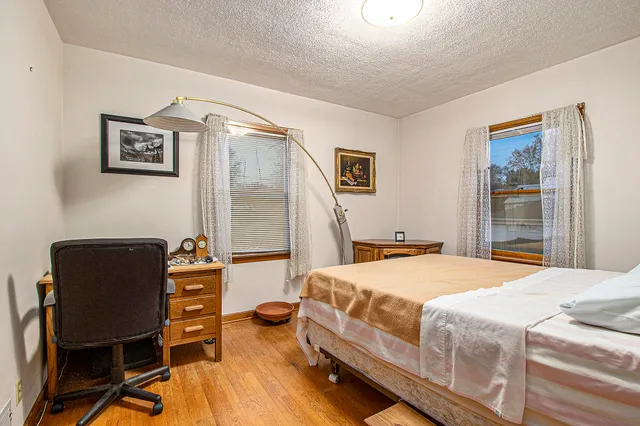 a bedroom with a bed and a chair