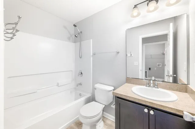 a view of a room with wooden floor and bathroom