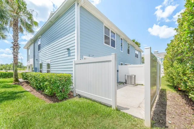 a view of a house with a garden and pathway