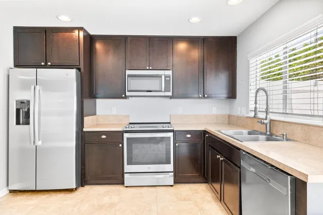 a kitchen with a sink and a refrigerator