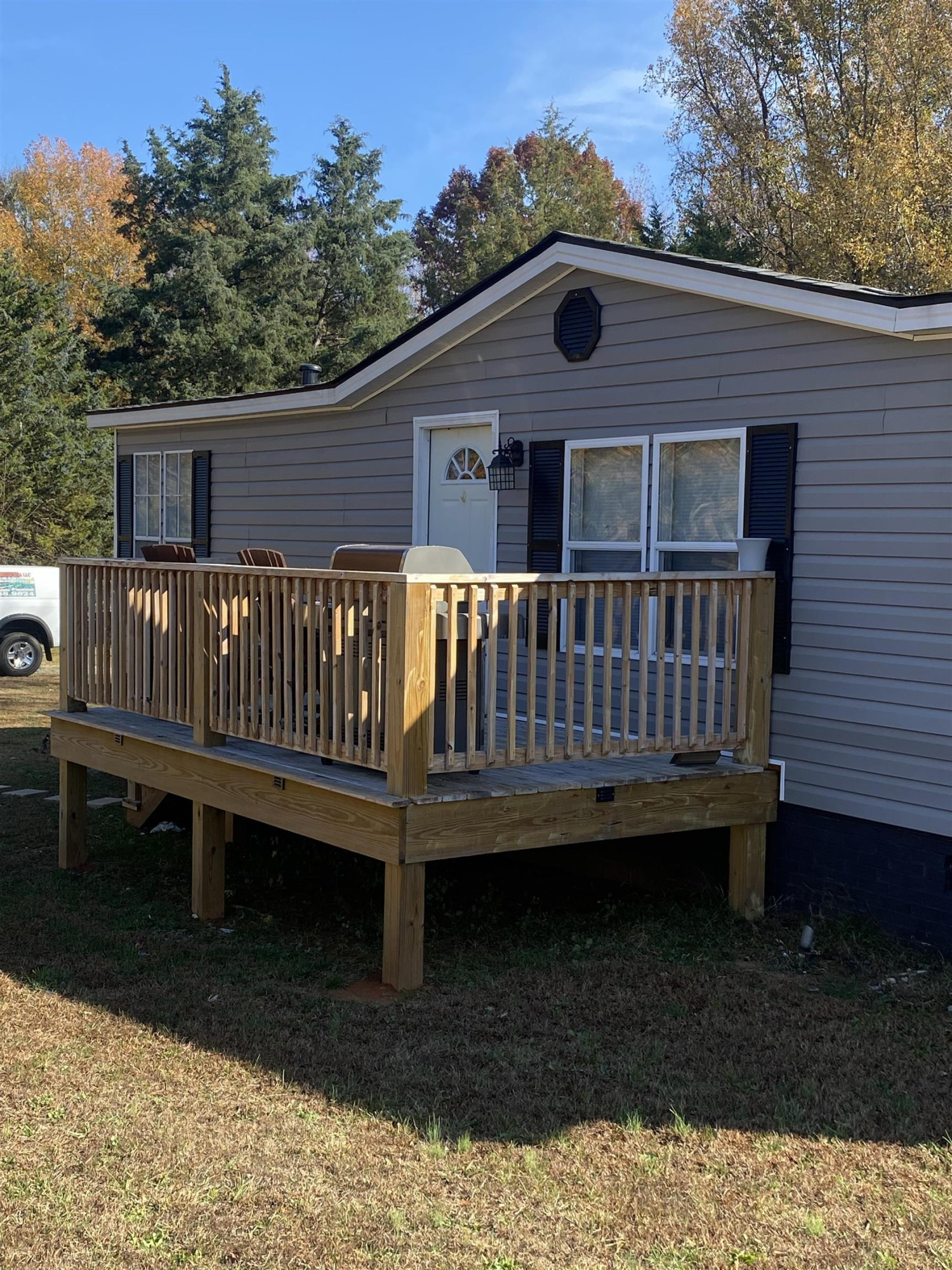 1658 Jack Clement Road Stem, NC 27581 - Photo 4 of 8 a view of a deck with a chair and wooden floor