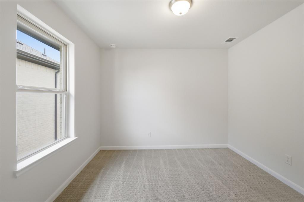 1908 Sangallo Lane Celina, TX 75009 - Photo 12 of 35 Spacious room featuring neutral carpeting, white painted walls, a single window with white trim, and a ceiling-mounted light fixture