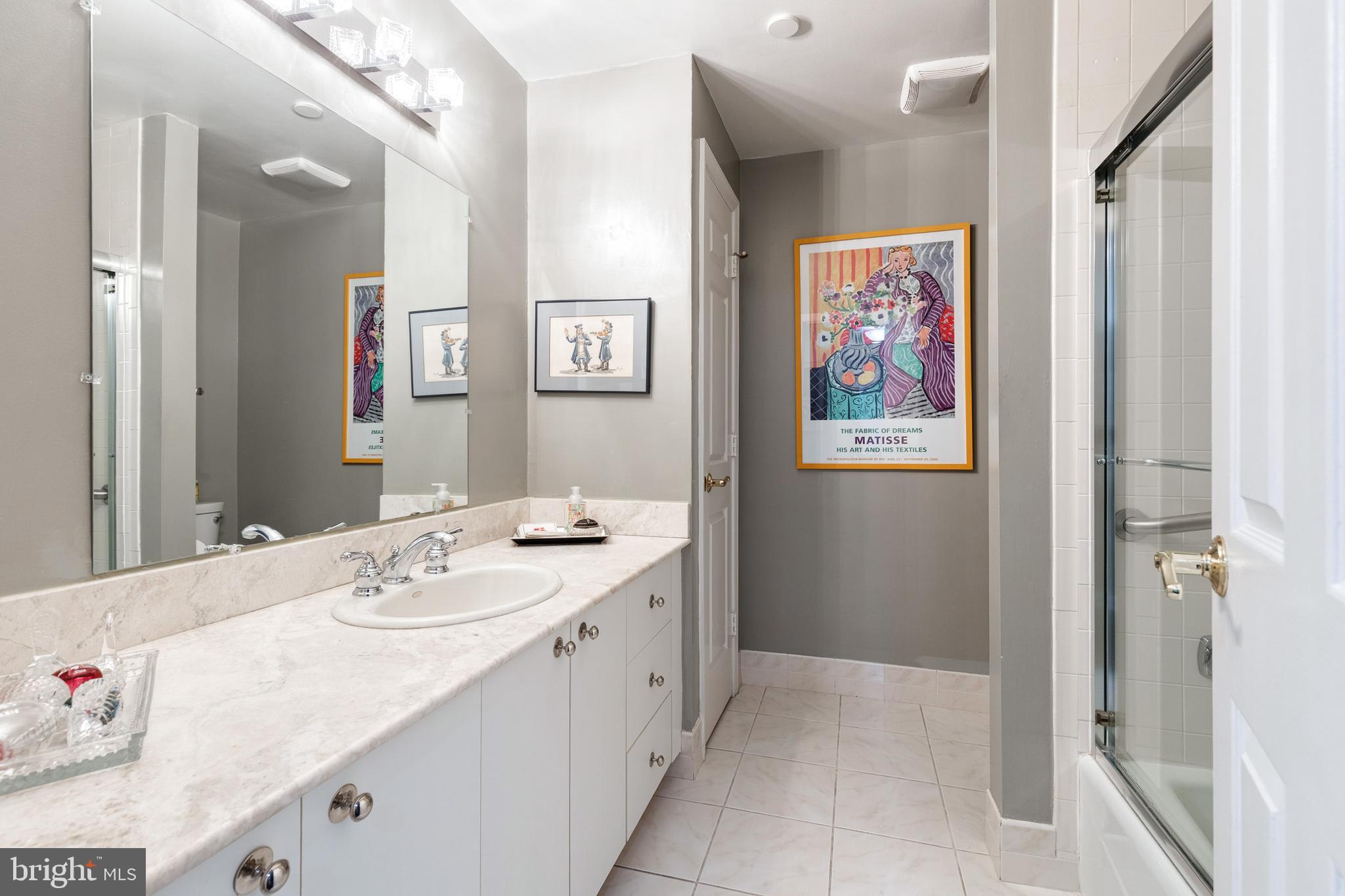 2331 Old Court Road, Unit 307 Baltimore, MD 21208 - Photo 16 of 35 a spacious bathroom with a tub sink and mirror
