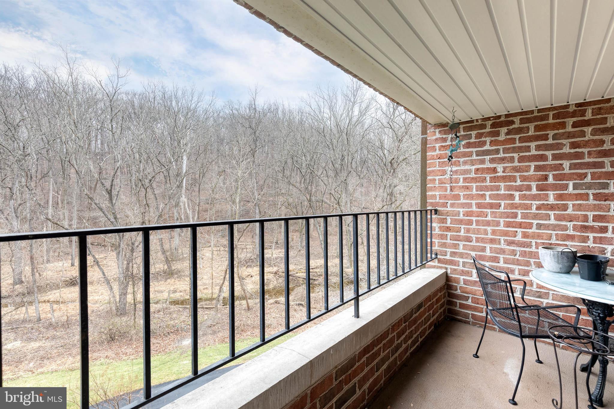 2331 Old Court Road, Unit 307 Baltimore, MD 21208 - Photo 18 of 35 a balcony with a bench and city view