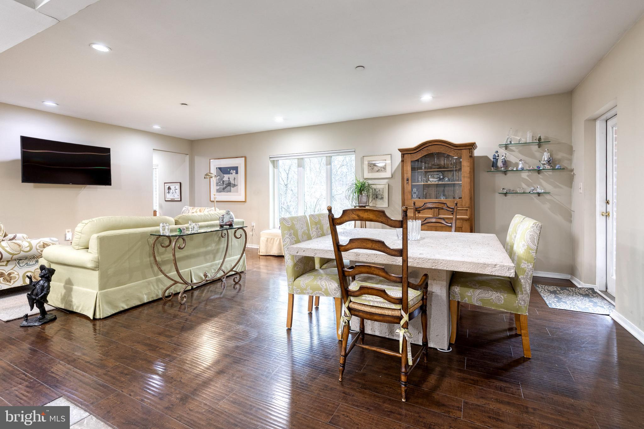 2331 Old Court Road, Unit 307 Baltimore, MD 21208 - Photo 2 of 35 a living room with furniture flat screen tv and wooden floor