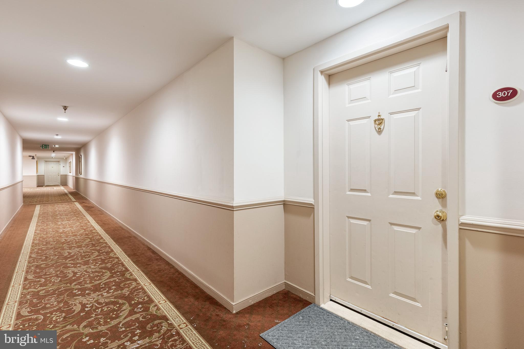 2331 Old Court Road, Unit 307 Baltimore, MD 21208 - Photo 22 of 35 a view of a hallway with wooden floor and staircase
