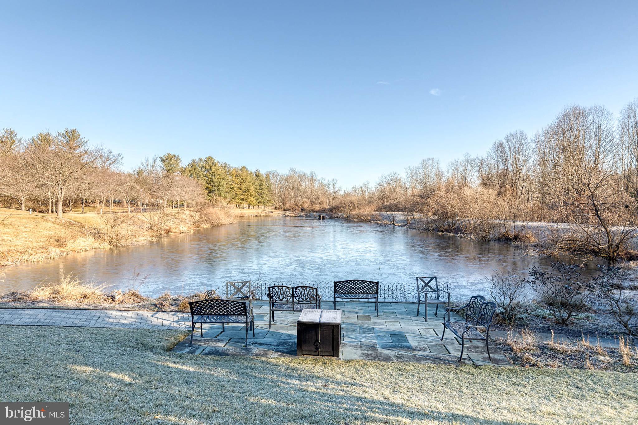 2331 Old Court Road, Unit 307 Baltimore, MD 21208 - Photo 28 of 35 a view of a lake with chairs and wooden fence