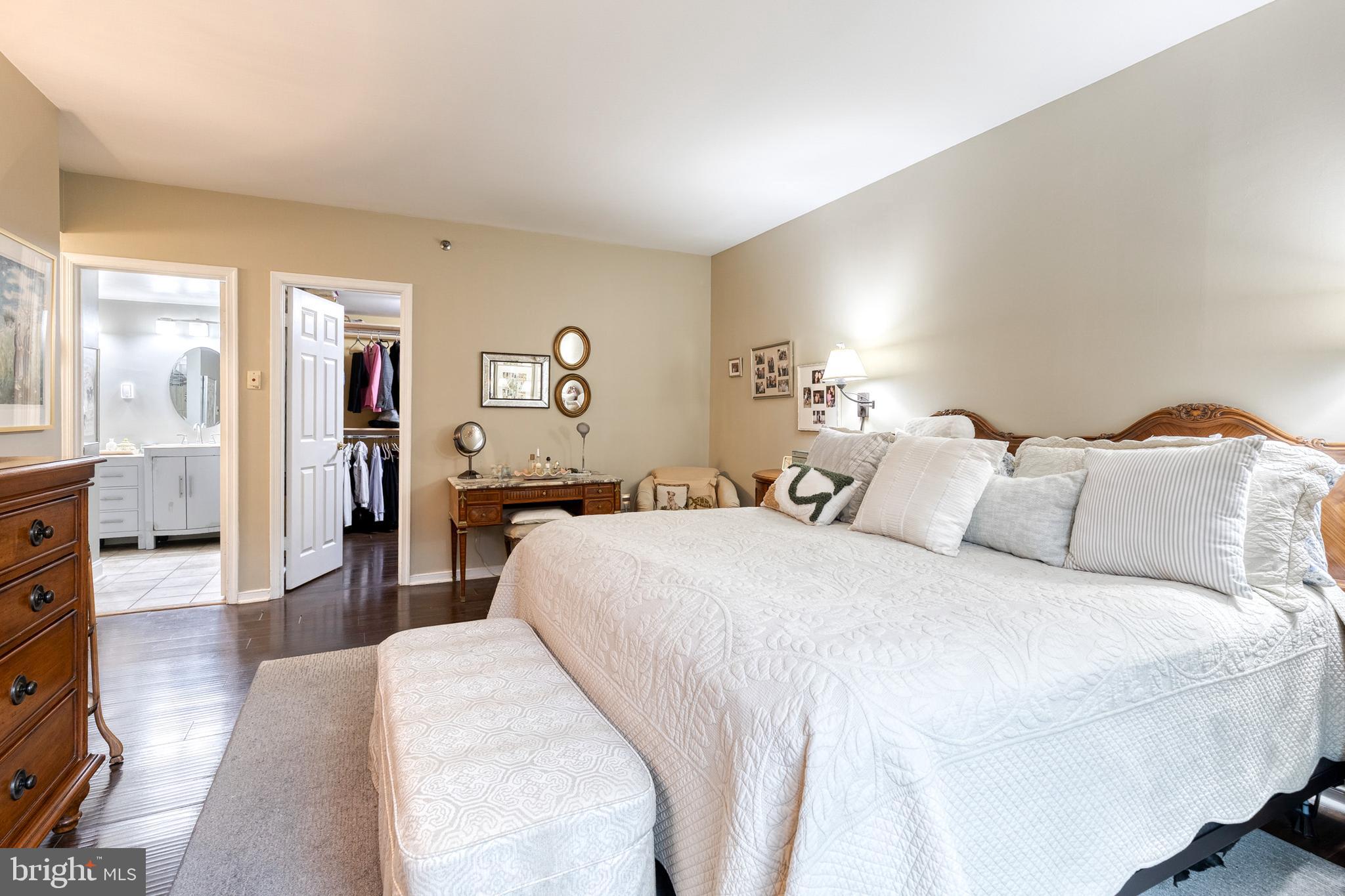 2331 Old Court Road, Unit 307 Baltimore, MD 21208 - Photo 10 of 35 a bedroom with a large bed and wooden floor