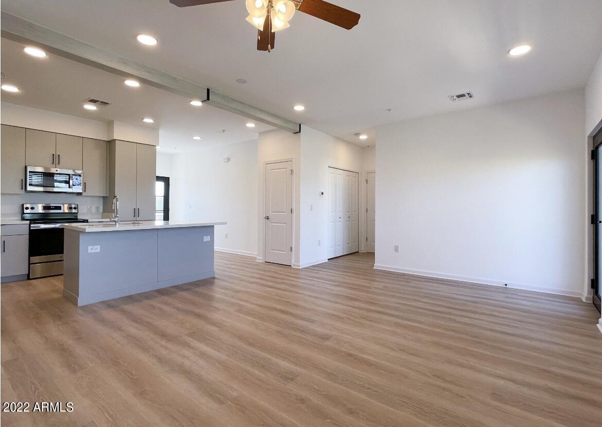 12412 North Saguaro Boulevard, Unit 303 Fountain Hills, AZ 85268 - Photo 12 of 48 a large kitchen with stainless steel appliances granite countertop a granite counter tops and a wooden floors