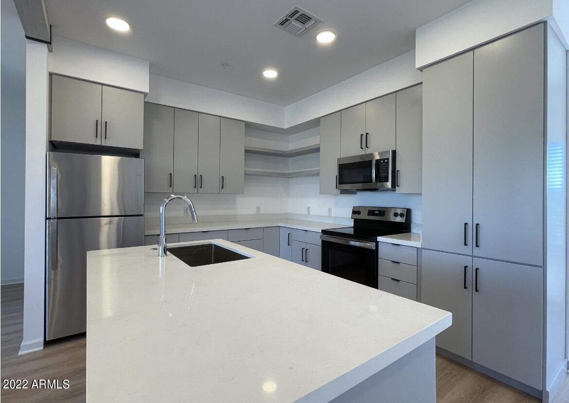 12412 North Saguaro Boulevard, Unit 303 Fountain Hills, AZ 85268 - Photo 15 of 48 a kitchen with a refrigerator sink and microwave