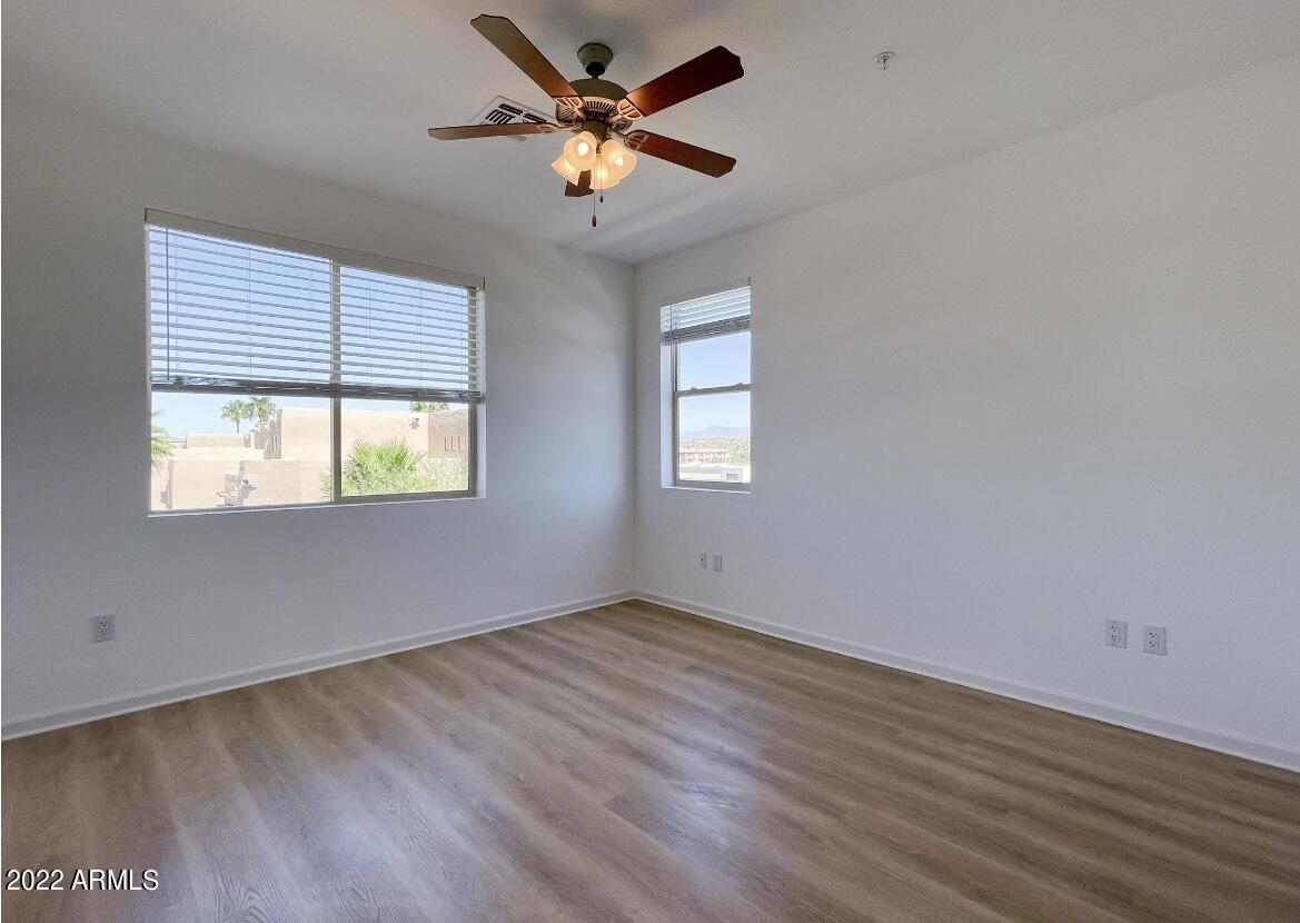 12412 North Saguaro Boulevard, Unit 303 Fountain Hills, AZ 85268 - Photo 22 of 48 wooden floor in an empty room with a window