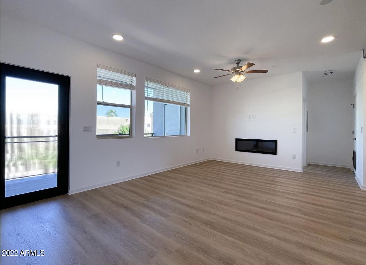 12412 North Saguaro Boulevard, Unit 303 Fountain Hills, AZ 85268 - Photo 23 of 48 a view of an empty room with a window and wooden floor