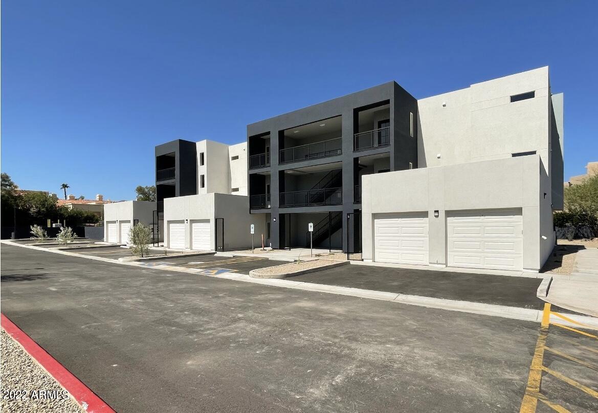 12412 North Saguaro Boulevard, Unit 303 Fountain Hills, AZ 85268 - Photo 5 of 48 a front view of a house with a yard and garage
