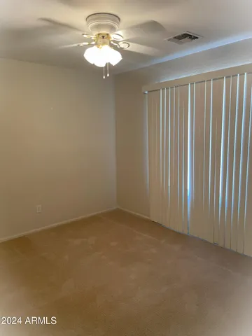 a view of a livingroom with a chandelier fan