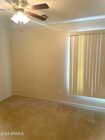 a view of a room with a window and a fan