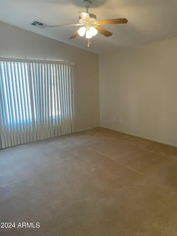 en empty room with windows and fan