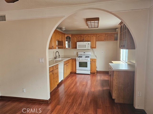 7754 Vía Rosa Maria Burbank, CA 91504 - Photo 5 of 13 a kitchen with stainless steel appliances granite countertop a stove a sink and a refrigerator