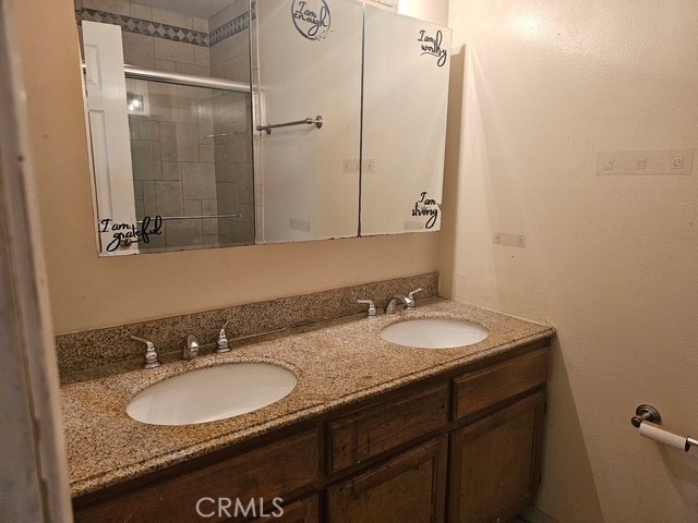 7754 Vía Rosa Maria Burbank, CA 91504 - Photo 6 of 13 a bathroom with a granite countertop sink and a mirror
