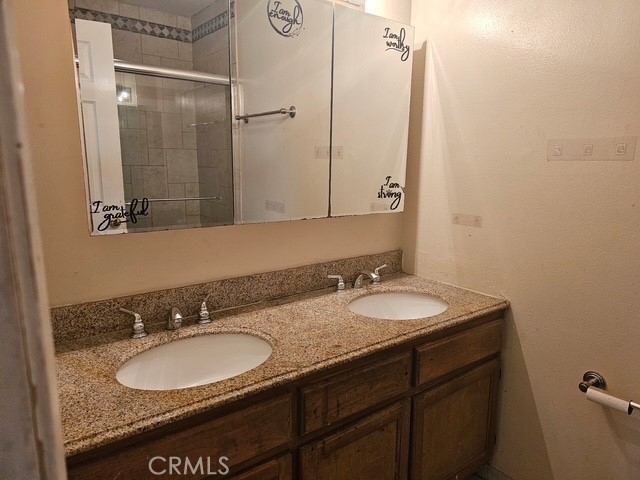 7754 Vía Rosa Maria Burbank, CA 91504 - Photo 7 of 13 a bathroom with a granite countertop sink and a mirror