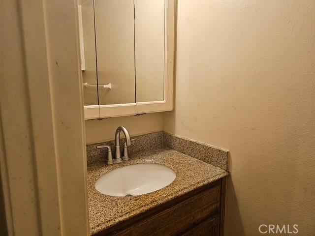 7754 Vía Rosa Maria Burbank, CA 91504 - Photo 10 of 13 a bathroom with a granite countertop sink and mirror