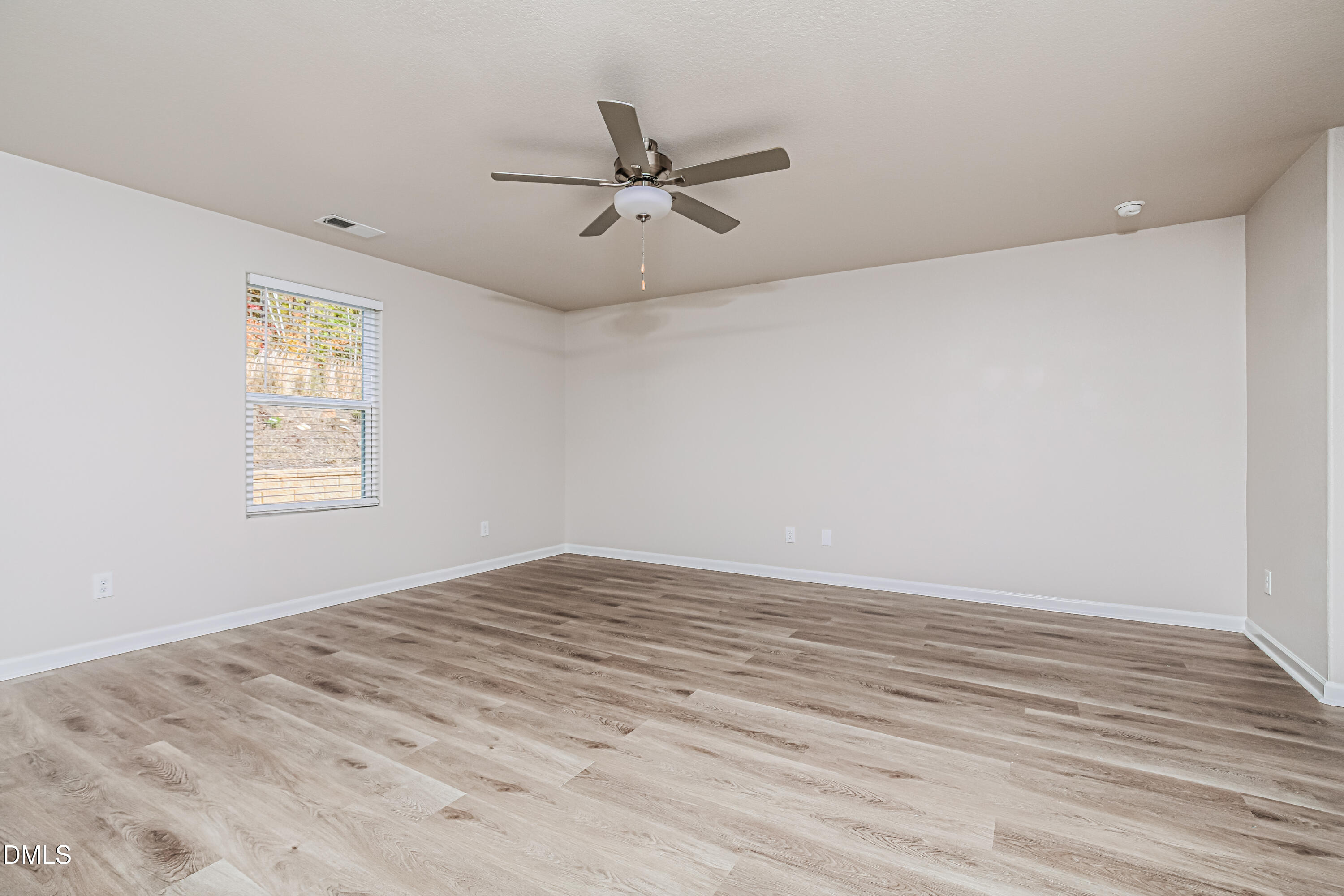 135 Shallow Drive Youngsville, NC 27596 - Photo 2 of 17 a view of empty room with wooden floor and fan