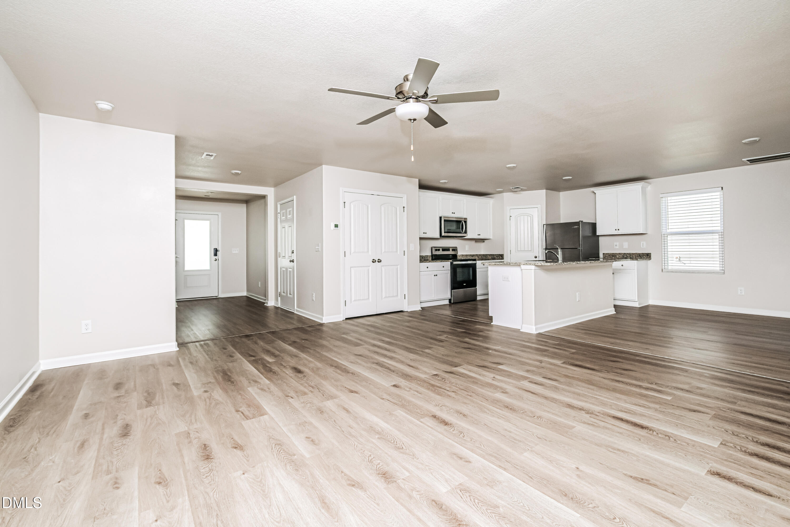 135 Shallow Drive Youngsville, NC 27596 - Photo 3 of 17 a view of a kitchen with a stove cabinets and wooden floor