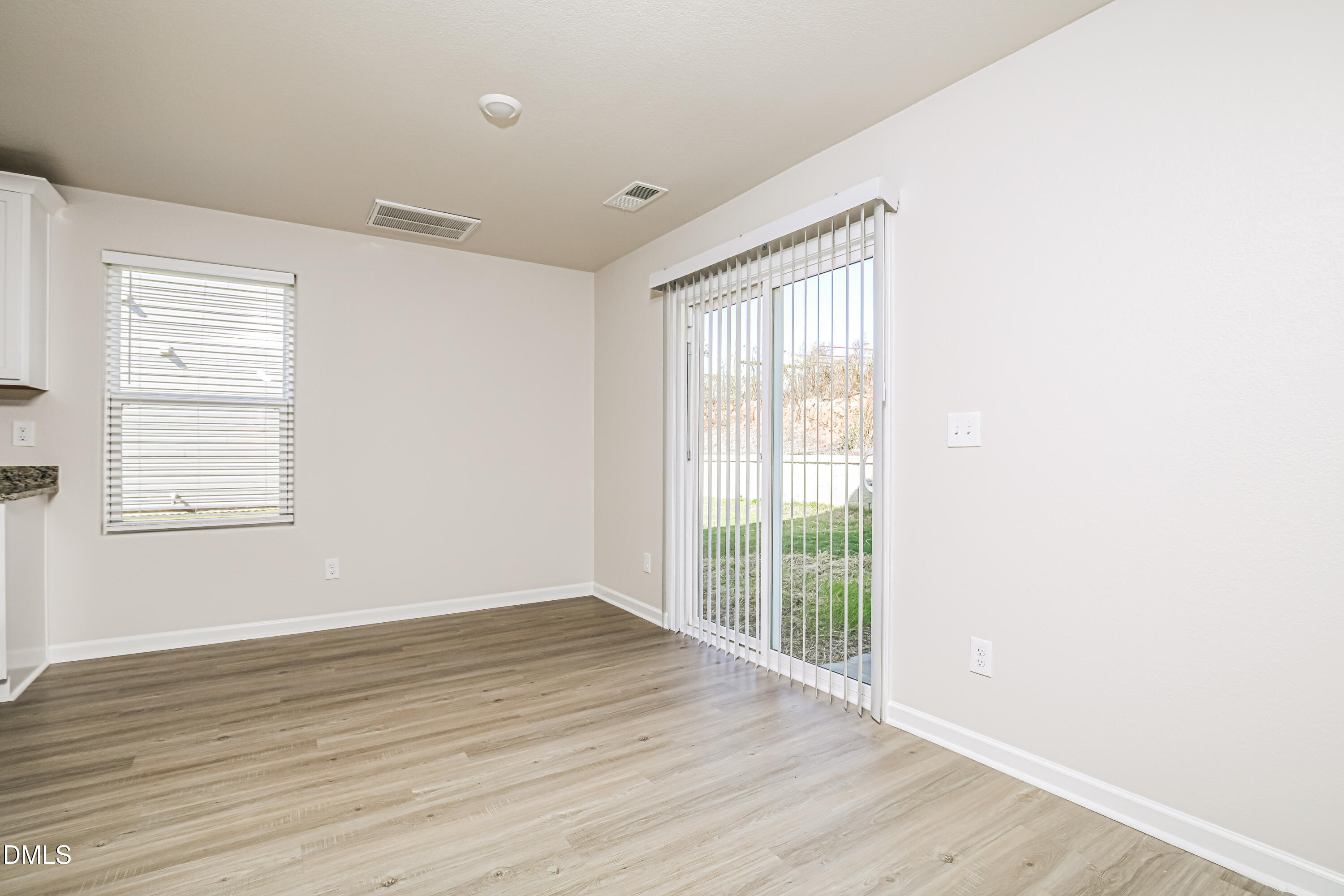 135 Shallow Drive Youngsville, NC 27596 - Photo 4 of 17 a view of an empty room with wooden floor and a window