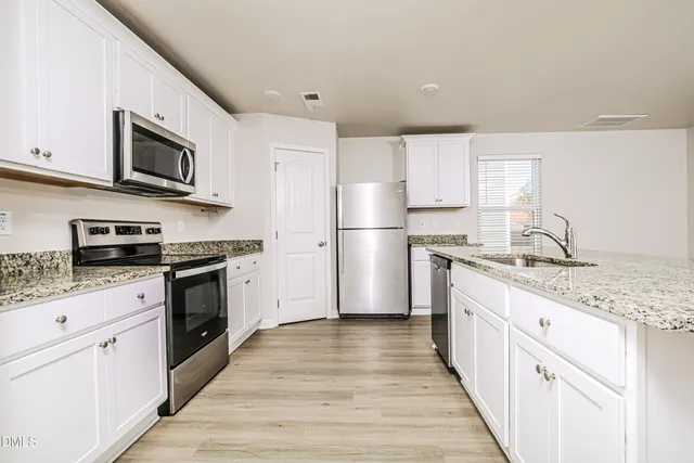 an empty room with fan and windows