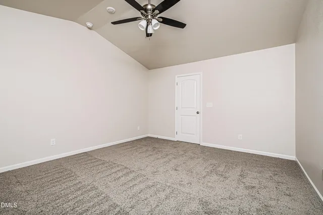 a bathroom with a granite countertop sink a toilet and a mirror