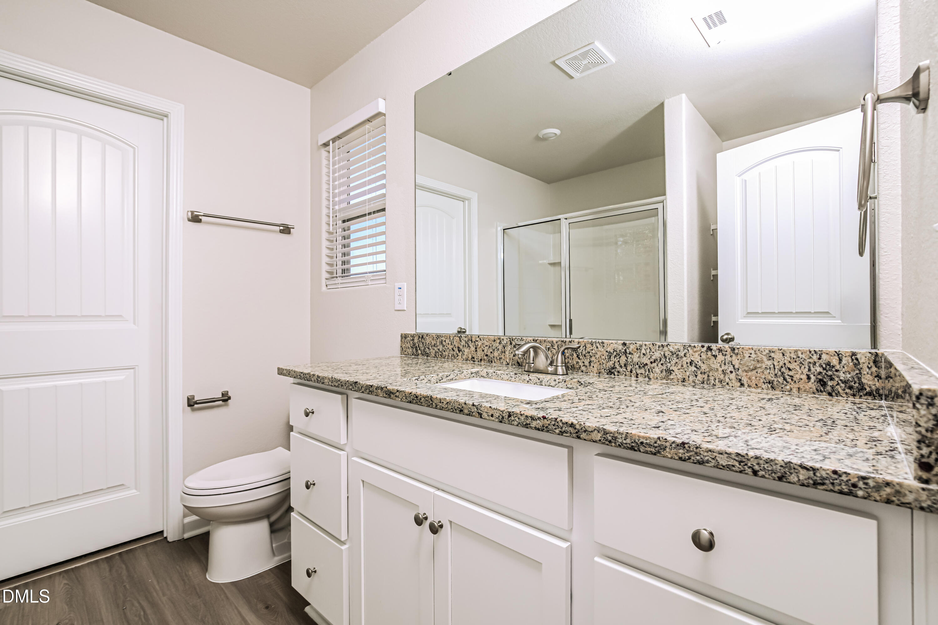 135 Shallow Drive Youngsville, NC 27596 - Photo 9 of 17 a bathroom with a granite countertop sink a toilet and a mirror