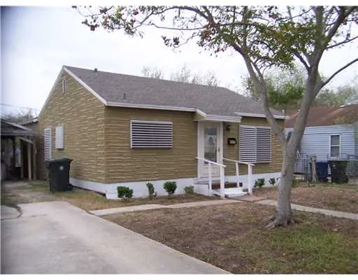 a view of a house with a yard and sitting area