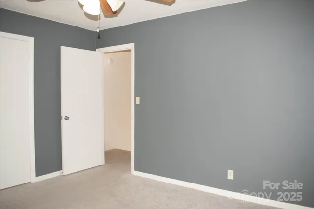 a kitchen with granite countertop white cabinets and black appliances