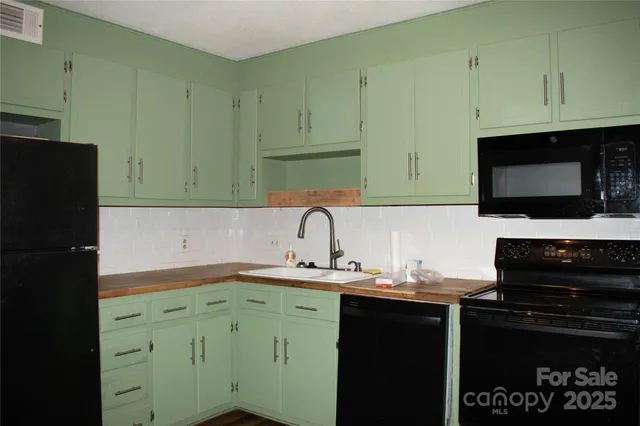 a kitchen with a sink and a refrigerator