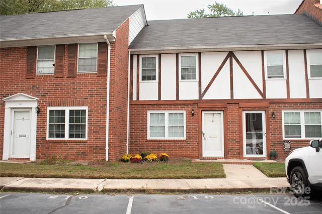 a front view of a house with a yard and outdoor seating