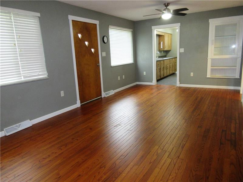 Nice 23 x 11' open floor plan for a living room/dining room combo! Features plaster walls, gleaming, newly refinished hardwood floors and two new lighted ceiling fans, one over the living room area and one over the dining area!