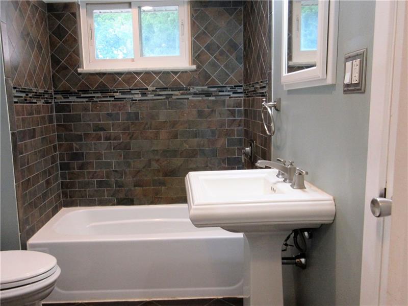 724 North Pike Road Cabot, PA 16023 - Photo 12 of 25 The bathroom has been updated and features a new ceramic tile floor and shower/tub, and recessed lighting.